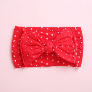 Bandeau élastique rouge pour bébé avec pois blancs et un grand nœud assorti