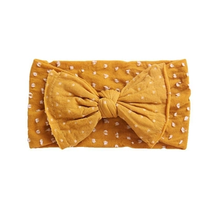 Bandeau bébé jaune avec grand nœud papillon et motif à pois en tissu doux