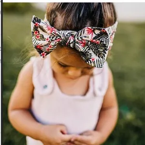 Detail view of baby headband with tropical palm leaf and flower print oversized bow