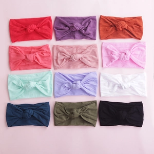Set of 12 soft nylon baby headbands with knot design in various colors for infants