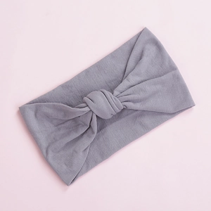 Detail shot of the soft grey nylon knot headband showing the fine knitted texture and fold