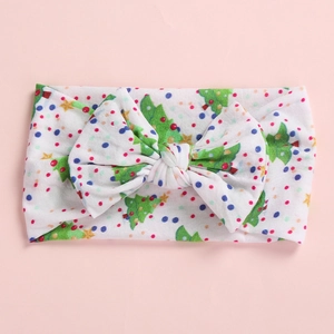 Close-up of baby headband with Christmas tree pattern and oversized bow detail
