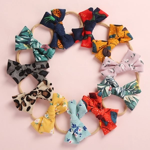 Set of 10 printed corduroy baby bow headbands with soft nylon bands for infants