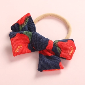 Detailed close-up of corduroy floral baby bow headband with high elastic nylon band