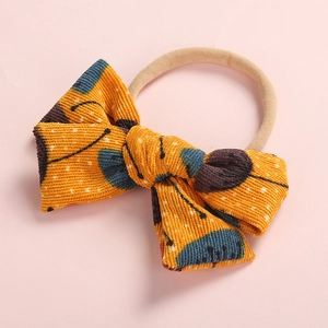 Orange corduroy floral baby headband with a soft nylon elastic bow for infants