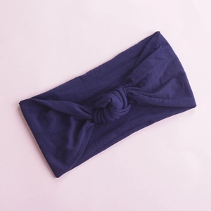 Close-up of soft purple elastic nylon headband with a stylish rabbit ear knot detail