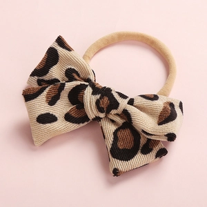 Close-up of leopard print corduroy bow headband with high elasticity nylon band for kids