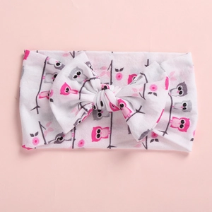 Soft baby headband with pink owl prints and a cute bow tie on a pink background