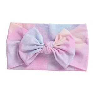 Soft elastic baby headband with tie-dye patterns and a large bow on white background