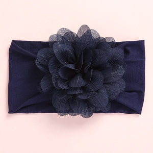 Detailed view of dark blue nylon baby headband with large multilayer chiffon flower deco