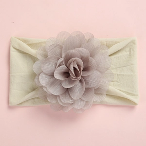 Detailed view of the large layered chiffon flower and soft nylon band for babies