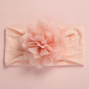 Detail of soft apricot chiffon flower on wide elastic nylon headband for baby girls