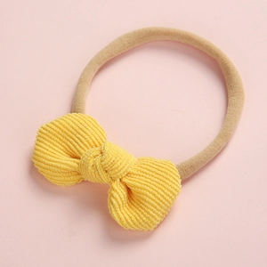 Détail d'un bandeau en velours côtelé jaune pour bébé avec bande en nylon extensible
