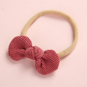 Détail d'un bandeau bébé avec nœud en velours côtelé rose et marron, nylon souple