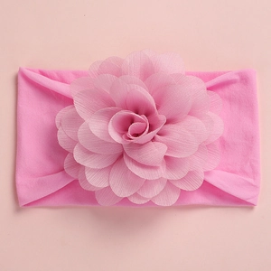 Close-up of pink baby headband featuring a large 3D layered chiffon flower decoration