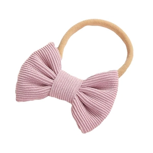Bandeau bébé avec nœud en velours côtelé rose et bande en nylon souple extensible