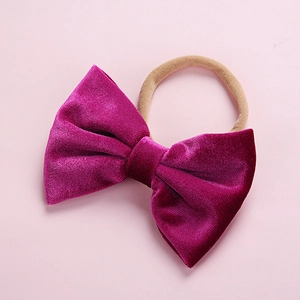 Soft magenta velvet bow headband for infants with seamless high-stretch nylon band