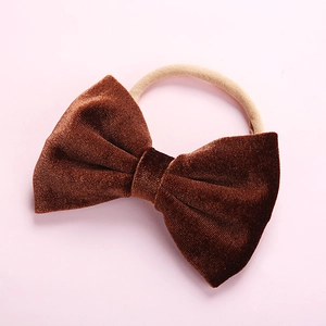 Detail of dark brown velvet bow headband with elastic seamless band for infants