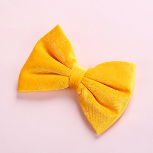 Close-up detail of high-grade yellow velvet bow hair clip for children with soft texture