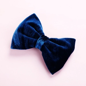 Detailed view of premium dark blue velvet bow hair clip with soft plush texture