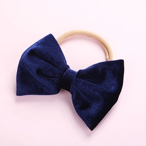 Detailed texture of navy velvet bow on high-elastic nylon headband for infants
