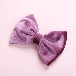 Detailed close-up of a soft purple velvet bow hair clip for children with plush texture