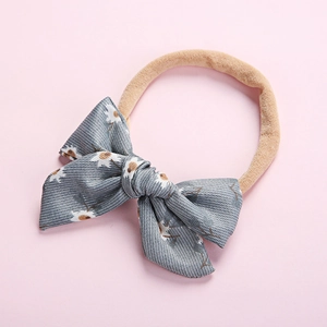 Detailed shot of grey floral daisy print bow on soft elastic baby headband