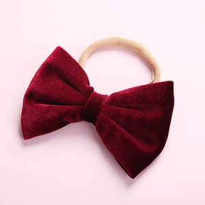 Close-up of soft velvet bow in deep red with high-elastic seamless headband