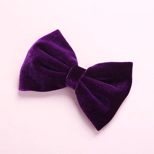 Close-up of deep purple velvet hair bow clip with soft texture and rich shine