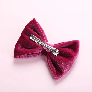 Detailed back view of a burgundy velvet bow hair clip with a sturdy silver metal alligator grip