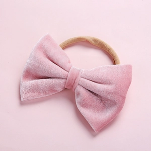 Close-up of soft pink velvet bow baby headband with high elasticity nylon strap