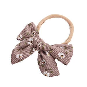 Floral baby headband with soft nylon strap featuring a printed cotton windmill bow
