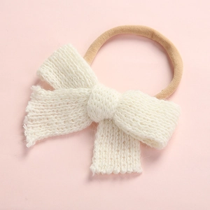 Detailed view of soft knit bow on high-elastic nylon headband for infants and babies