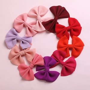 Set of colorful waffle fabric bow hair clips for kids in various soft pastel colors