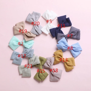Detailed palette of 12 colorful cotton linen bow hair clips with textile texture labels