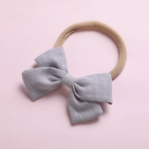 Détail du nœud en lin gris clair et du bandeau souple en nylon pour les nourrissons