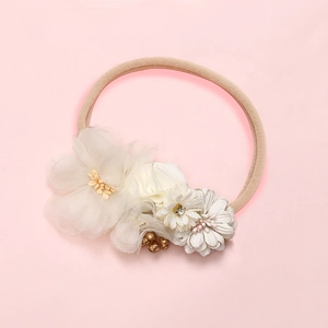 Detail of infant floral headband with soft lace flowers and pearl rhinestone center deco