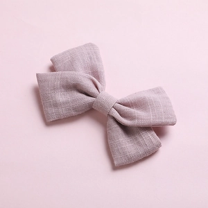 Close-up of light purple cotton bow hair clip showing detailed woven fabric texture