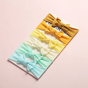 Set of 6 soft nylon baby headbands with knot bows in assorted pastel colors on card