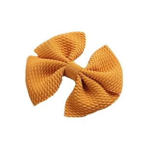 Classic mustard yellow bow hair clip with textured bubble fabric for children