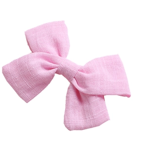 Minimalist pair of pink cotton bow hair clips with textured bamboo cotton fabric for girls