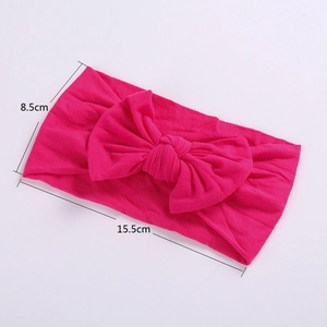 Detail showing soft rose red nylon bow headband with 15.5cm x 8.5cm size dimensions