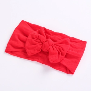 Bright red baby bow headband made of soft textured knitted nylon for infants and toddlers