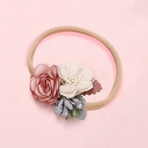 Detailed close-up of elastic nylon headband with dried pink roses and green leaves