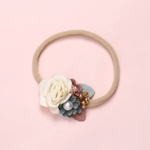 Handmade floral baby headband featuring cream roses and berries on elastic brown band