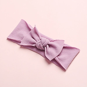 Macro shot of light purple seamless nylon baby headband with soft ribbed texture bow