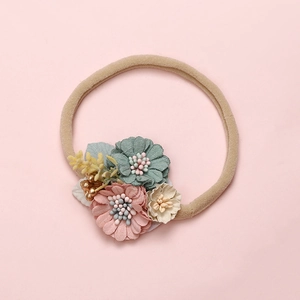 Detailed texture of baby flower headband with soft nylon band and pastel fabric petals