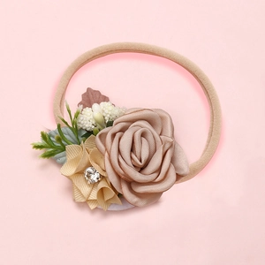 Detailed shot of handmade fabric flowers and rhinestone petals on a soft nylon headband