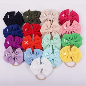 Detail of waffle fabric baby headbands showing 17 color options with elastic nylon bands