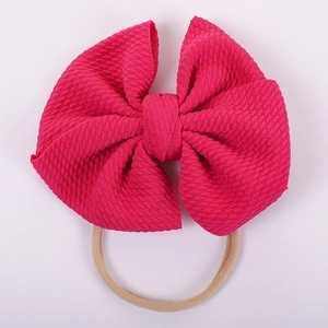 Close-up of rose red waffle fabric double layered bow with high elastic nylon headband